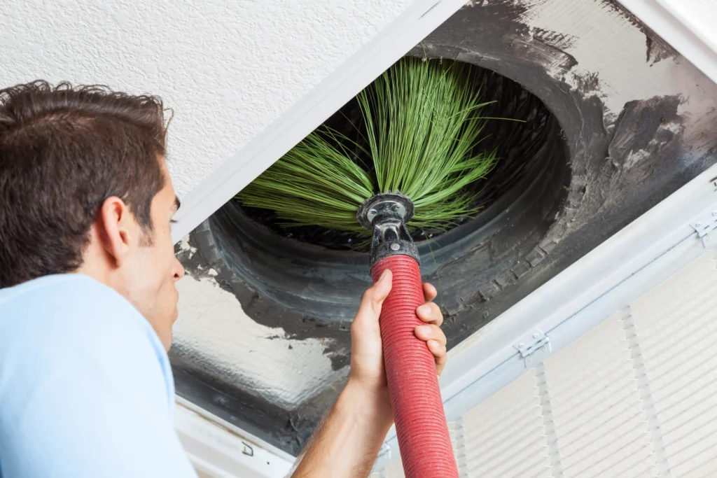 A man performing Air Duct Cleaning in Couer d'Alene, ID