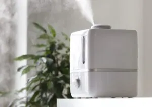 A white humidifier releasing mist on a white surface promoting whole-home humidifiers in Coeur d'Alene, ID.